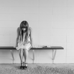Picture of women sitting down hunched over